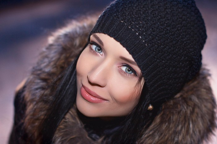 Portrait of Woman with Blue Eyes and Black Knit Hat