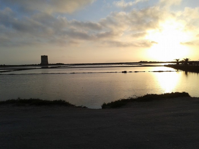 Salt pans with tower at sunset in Sicily