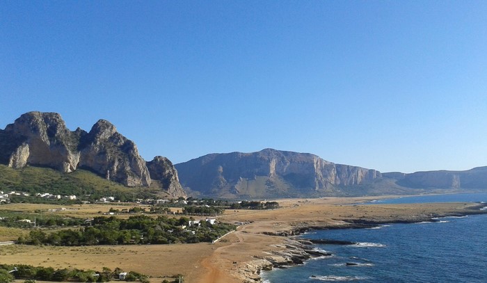 Mountainous coastline of Sicily with rocky cliffs and blue sea