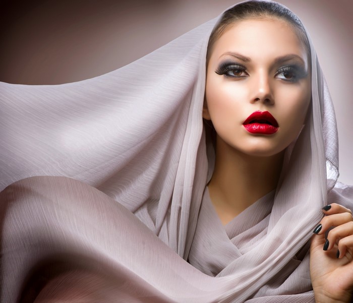 Woman with dramatic makeup and headscarf