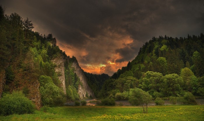 Stormy sky over a mountain valley with a river