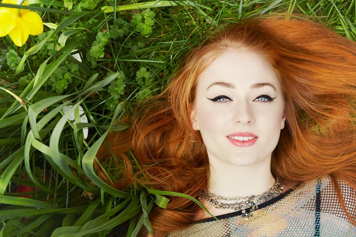 Portrait of a Redhead Woman Lying in Grass