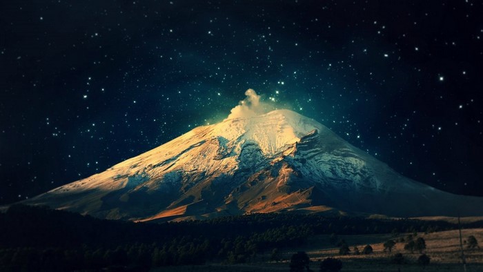 Snow-capped volcano under a starry night sky