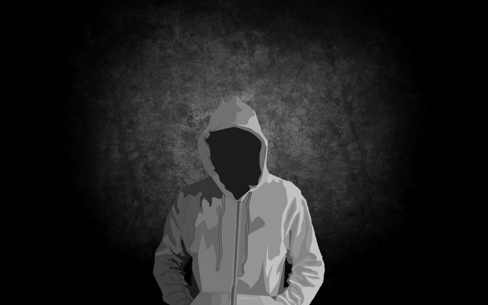 Person in a hoodie with a dark background