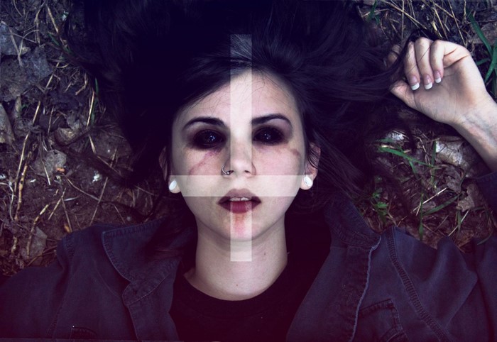 Woman with dark makeup and inverted cross overlay