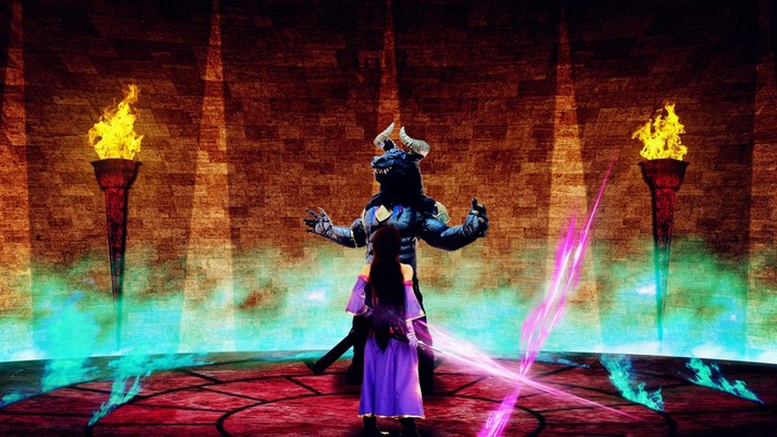 A woman faces a beast-like creature on a stage