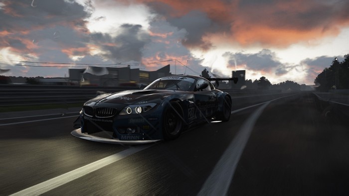 BMW Z4 GT3 race car on a track at sunset