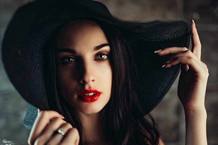 Woman in black hat with red lipstick