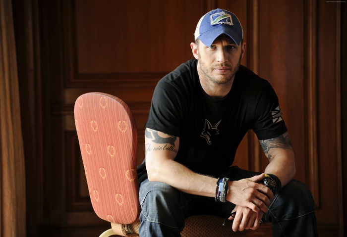 Tom Hardy wearing a blue baseball cap and black t-shirt