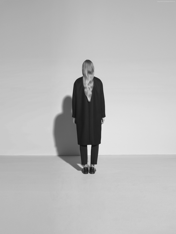 Model Kasia Bielska wearing a black coat and pants
