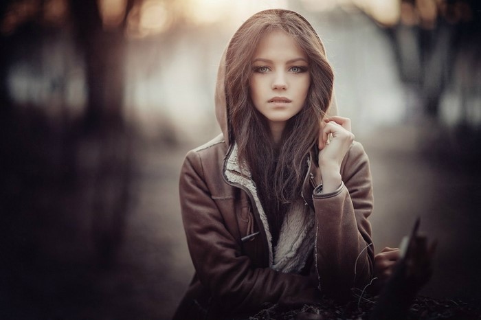Woman with long brown hair wearing a hooded jacket