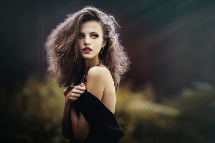 Woman with long brown hair in black dress