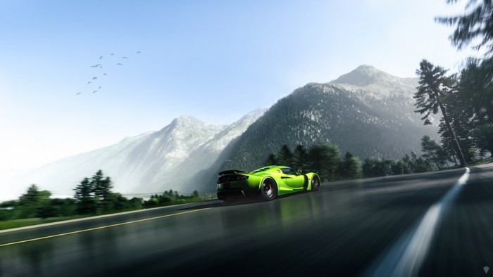 Green supercar driving on a mountain road