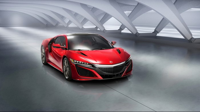 Red Acura NSX sports car in a modern garage