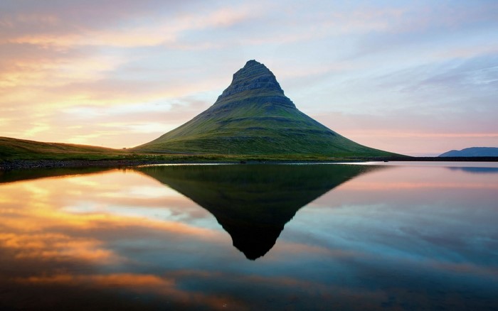 Kirkjufell mountain reflected in water at sunset, Iceland