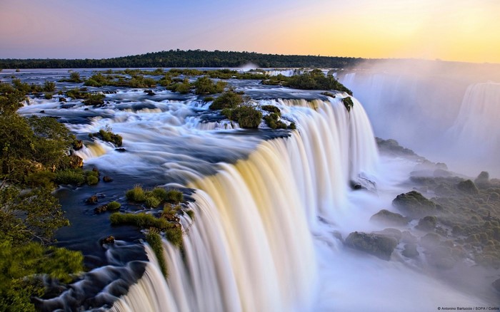 Iguazu Falls at sunset with mist
