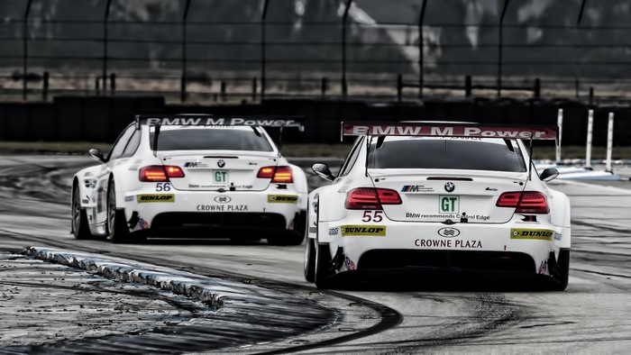 Two BMW M Power race cars on a track