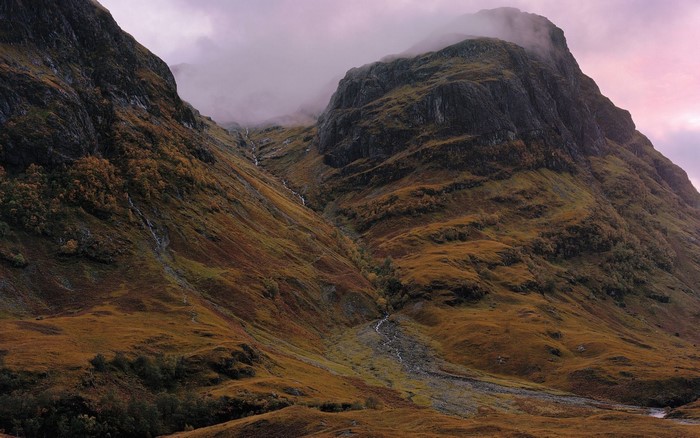 Mountain valley with streams and fog