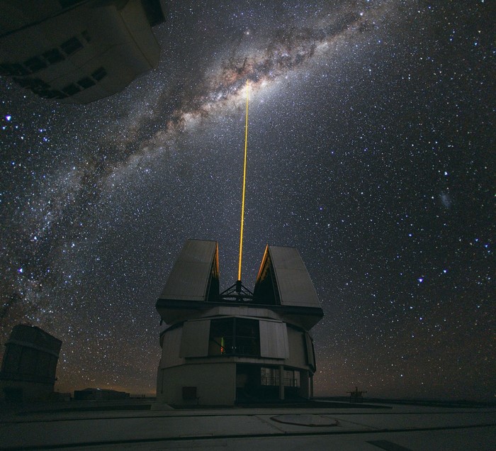 Observatory with laser beam pointing to the Milky Way
