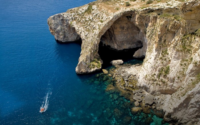 Blue Grotto sea cave in Malta with a boat