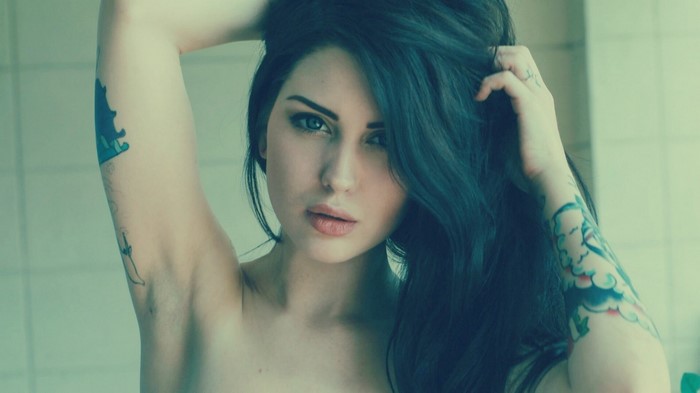 Woman with tattoos and black hair