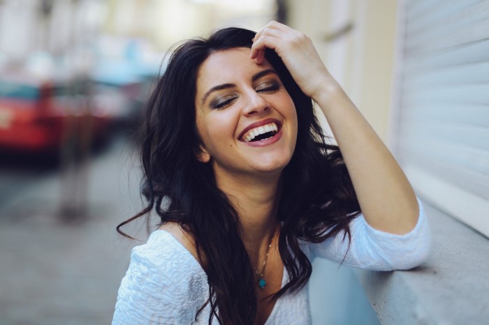 Aurela Skandaj laughing with hand on head