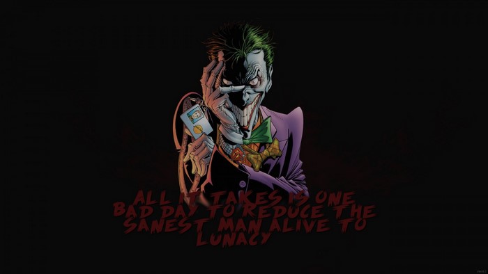 The Joker from Batman Begins holding a playing card