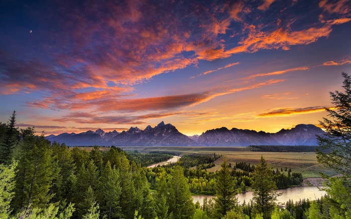 Sunset over mountains with river and forest