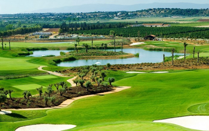 Golf course with a lake and surrounding landscape