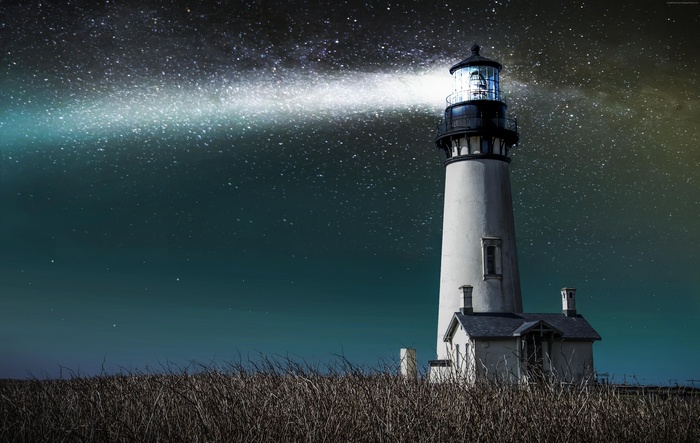Lighthouse under the starry night sky