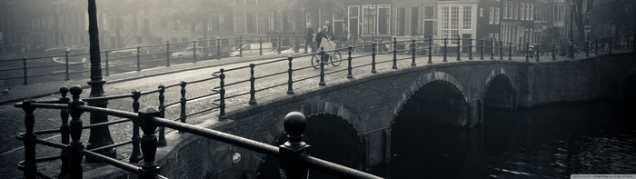 Monochrome bridge with people and bicycle in Amsterdam