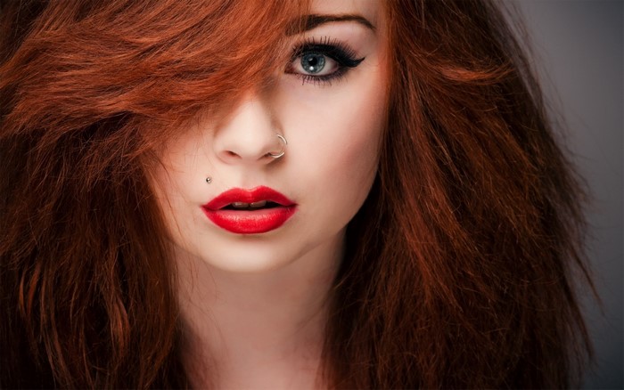 Close-up Portrait of a Redhead Woman with Pierced Nose