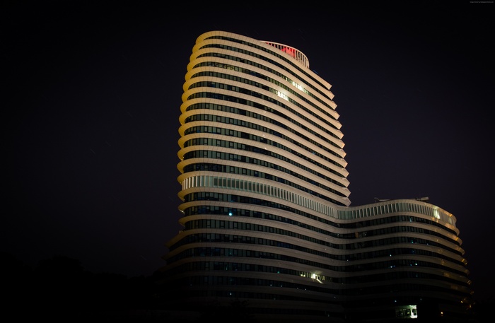 Curved skyscraper at night in the Netherlands