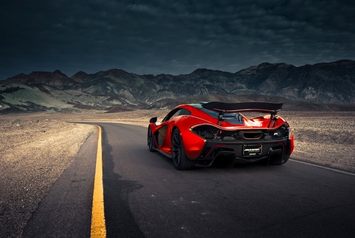 Red McLaren P1 driving on a desert road