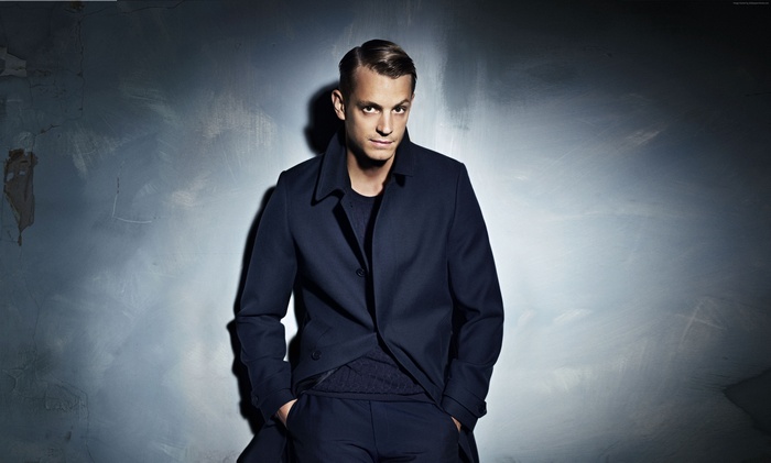 Joel Kinnaman wearing a dark coat