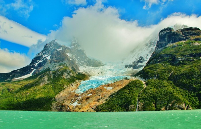 Glacier flowing into a turquoise lake in Patagonia