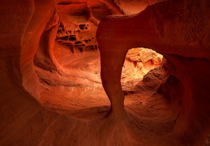 Orange sandstone cave formation with natural arch