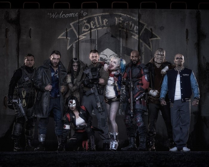Suicide Squad characters in front of Belle Reve sign
