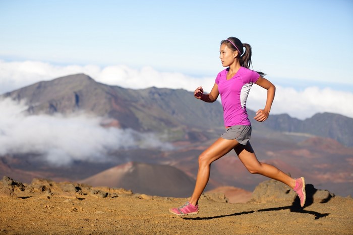 Woman running on a mountain trail