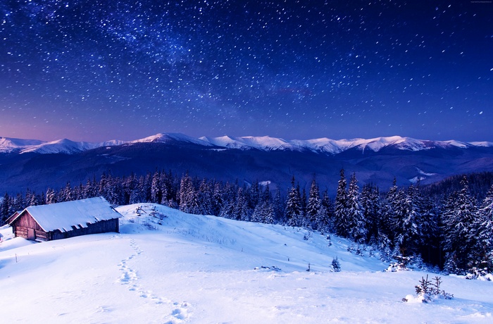 Snowy Mountains at Night with Stars and Cabin