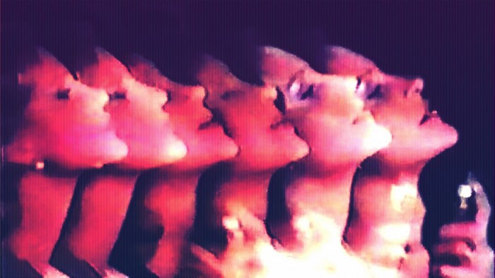 Multiple exposures of a woman's face with red and purple lighting