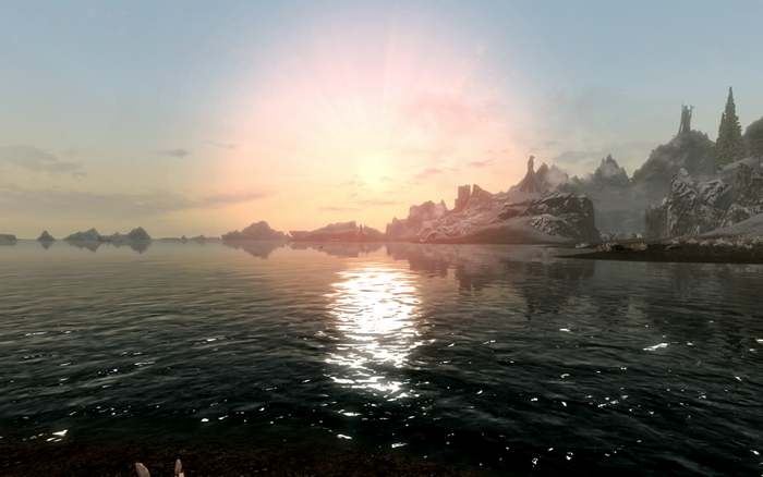 The Elder Scrolls V Skyrim: Sunrise over a calm sea with mountains