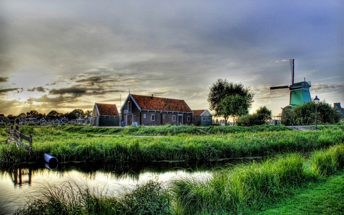 Dutch village with windmill and canal