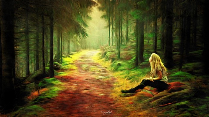 Woman sitting on a path in a forest