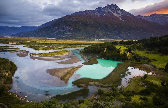 Turquoise lake and river in Patagonia with mountains