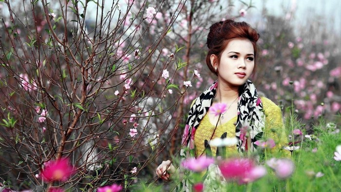 Woman in yellow dress with pink blossoms