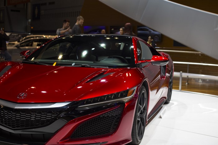 Red Acura NSX sports car at an auto show