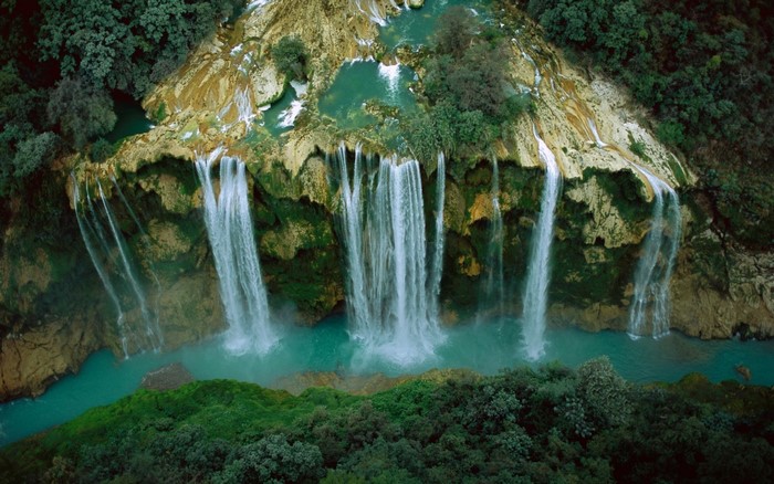 Aerial view of waterfalls cascading into a turquoise river in Mexico