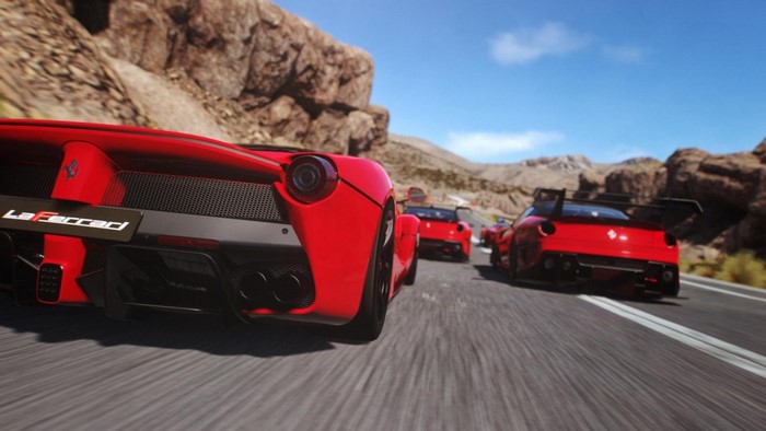 Red Ferraris racing on a desert road in Driveclub