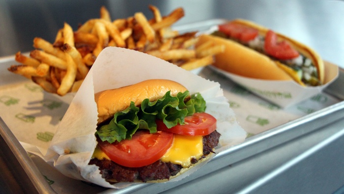Burger, hot dog, and french fries on a tray